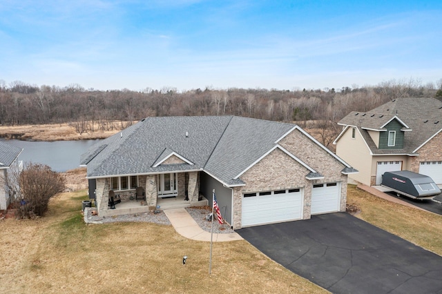 707 Bergman Ct NW, Isanti, MN 55040 - ranch-style house featuring driveway, french doors, an attached garage, a front yard, and a shingled roof