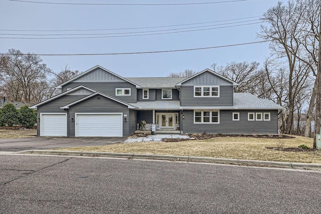 925 Minnesota Ln N, Plymouth, MN 55447 - view of front of house with french doors, an attached garage, aphalt driveway, and roof with shingles