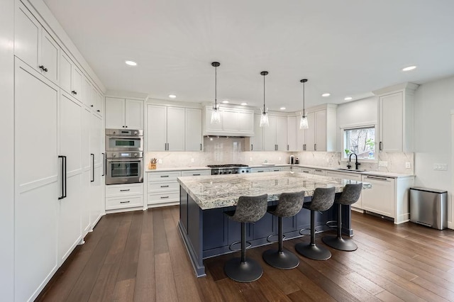 925 Minnesota Ln N, Plymouth, MN 55447 - kitchen featuring white dishwasher, a sink, stainless steel double oven, white cabinets, and a kitchen island