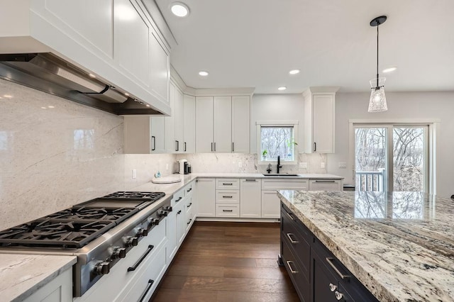 925 Minnesota Ln N, Plymouth, MN 55447 - kitchen with white cabinets, recessed lighting, a sink, wall chimney exhaust hood, and stainless steel gas cooktop