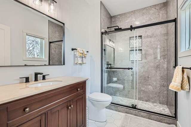 925 Minnesota Ln N, Plymouth, MN 55447 - bathroom featuring toilet, vanity, tile patterned floors, and a stall shower