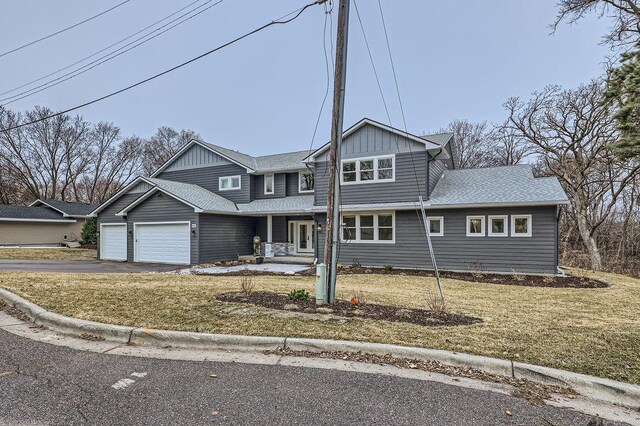 925 Minnesota Ln N, Plymouth, MN 55447 - traditional-style house featuring a front lawn, aphalt driveway, board and batten siding, and an attached garage