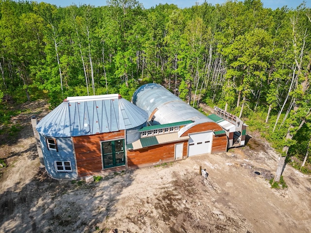 32838 County 16, Hart Lake Twp, MN 56461 - view of front of home with a garage, driveway, a standing seam roof, a view of trees, and metal roof