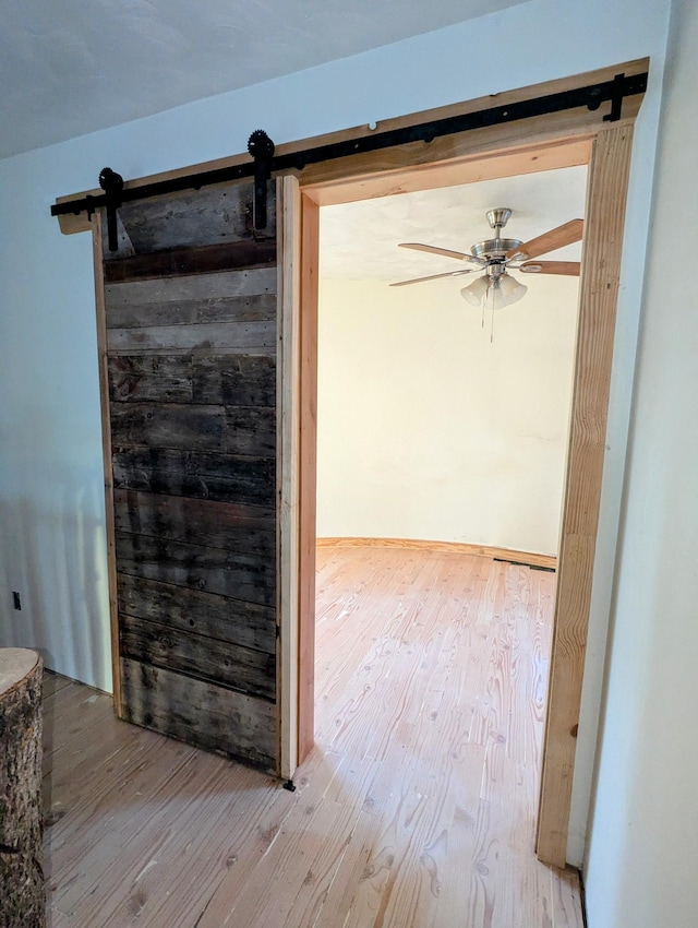 32838 County 16, Hart Lake Twp, MN 56461 - interior space with a barn door, wood finished floors, and a ceiling fan