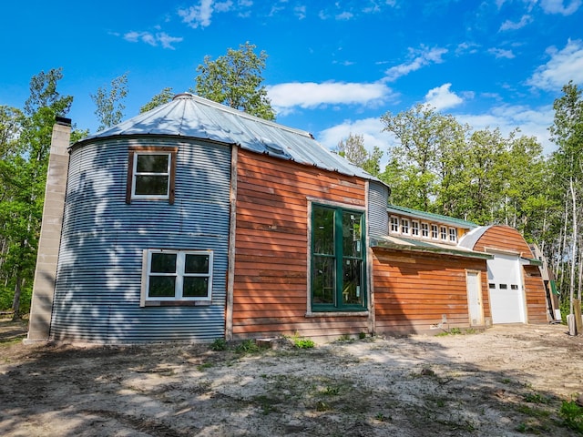 32838 County 16, Hart Lake Twp, MN 56461 - back of house with a garage, a chimney, and a metal roof