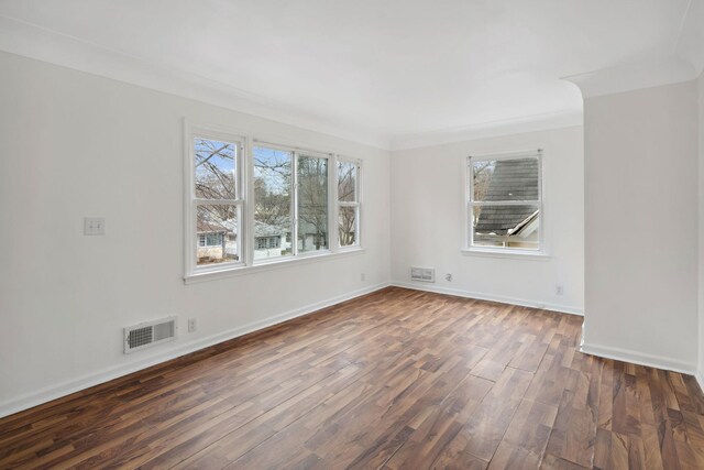 1119 6th St E, Saint Paul, MN 55106 - unfurnished room with visible vents, baseboards, plenty of natural light, and dark wood finished floors