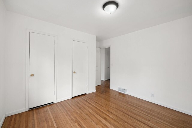 1119 6th St E, Saint Paul, MN 55106 - unfurnished bedroom featuring light wood finished floors, baseboards, and visible vents