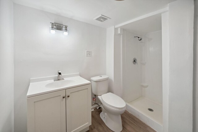 1119 6th St E, Saint Paul, MN 55106 - full bath featuring a shower, visible vents, toilet, and wood finished floors