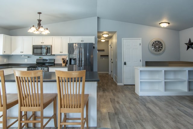 18885 Maryville Rd, Brainerd, MN 56401 - kitchen with appliances with stainless steel finishes, lofted ceiling, dark countertops, a chandelier, and open shelves