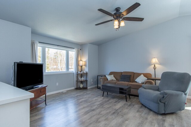 18885 Maryville Rd, Brainerd, MN 56401 - living room featuring light wood-style floors, baseboards, vaulted ceiling, and ceiling fan
