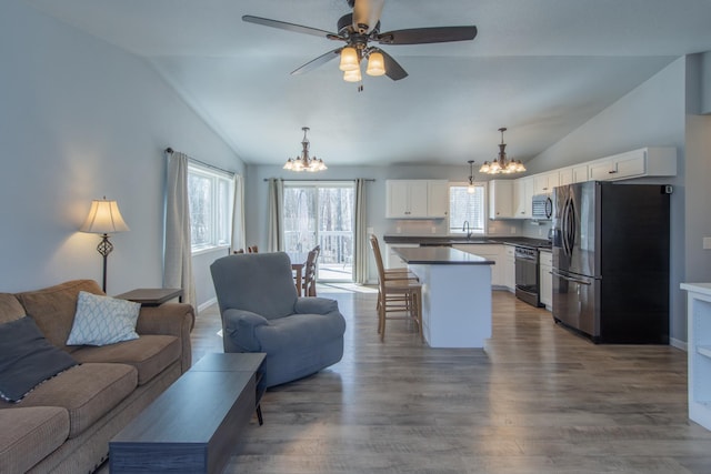 18885 Maryville Rd, Brainerd, MN 56401 - living area with a chandelier, lofted ceiling, ceiling fan, and wood finished floors