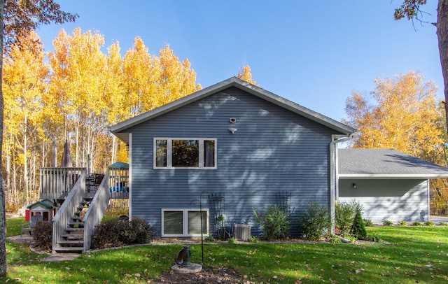 18885 Maryville Rd, Brainerd, MN 56401 - rear view of house with a lawn, stairway, a wooden deck, and central AC