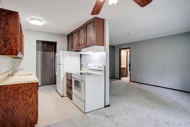 702 Old Settlers Trl Unit 3, Hopkins, MN 55343 - kitchen with white appliances, under cabinet range hood, ceiling fan, light carpet, and light countertops