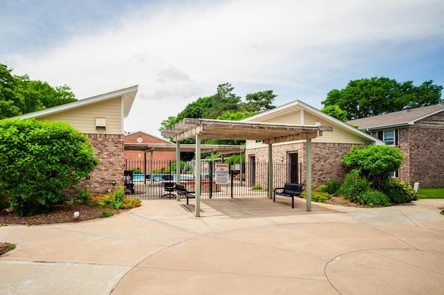 702 Old Settlers Trl Unit 3, Hopkins, MN 55343 - view of patio featuring a pergola and a gate