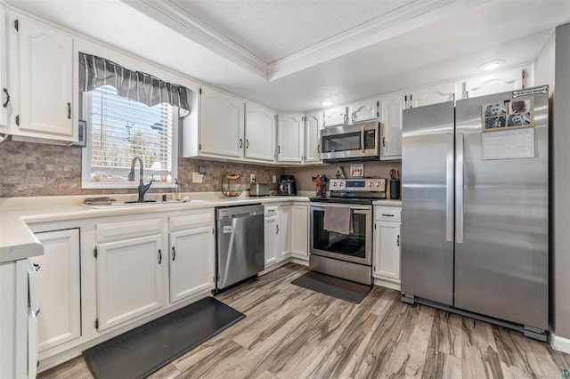4463 Singkoffer Rd, Summit Twp, WI 54880 - kitchen featuring stainless steel appliances, ornamental molding, a sink, backsplash, and white cabinets