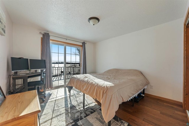 4463 Singkoffer Rd, Summit Twp, WI 54880 - bedroom with access to exterior, wood finished floors, baseboards, and a textured ceiling