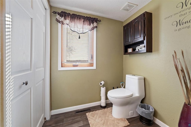 4463 Singkoffer Rd, Summit Twp, WI 54880 - bathroom with wood finished floors, toilet, baseboards, and a closet