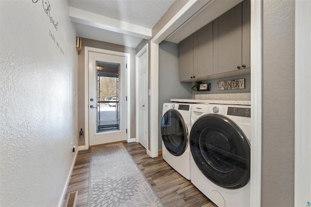 4463 Singkoffer Rd, Summit Twp, WI 54880 - washroom featuring washing machine and clothes dryer, cabinet space, light wood-style flooring, and baseboards