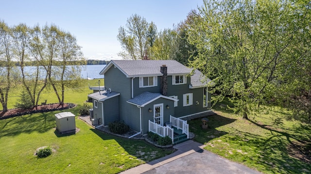 4463 Singkoffer Rd, Summit Twp, WI 54880 - view of front of house featuring a water view, a shingled roof, and a front lawn