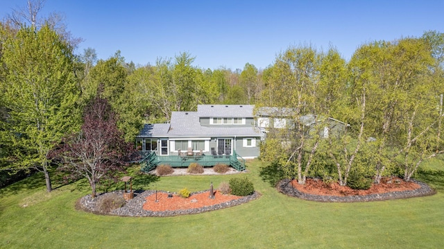 4463 Singkoffer Rd, Summit Twp, WI 54880 - rear view of house featuring a lawn, a deck, and a wooded view