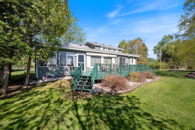 4463 Singkoffer Rd, Summit Twp, WI 54880 - back of property with a wooden deck, a lawn, and stairs