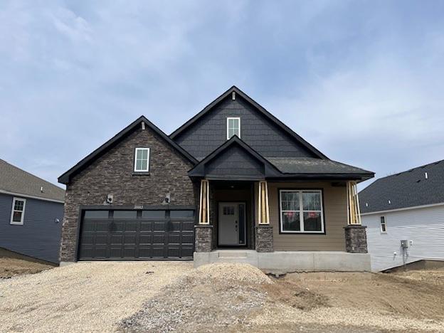 craftsman-style house with dirt driveway