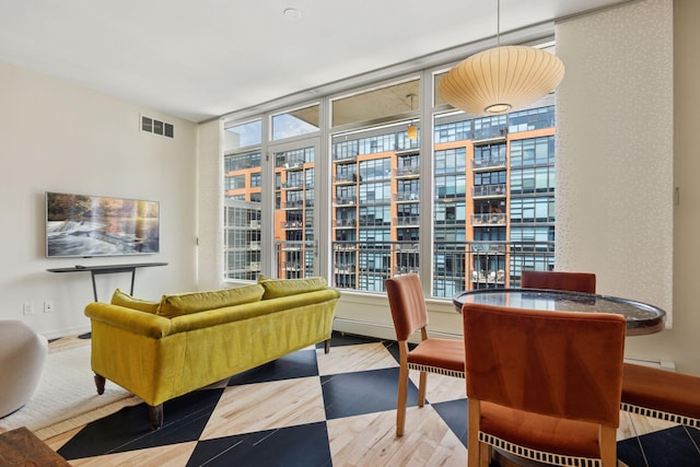 215 10th Ave S Unit 633, Minneapolis, MN 55415 - sitting room featuring healthy amount of natural light, wood finished floors, and a wall of windows