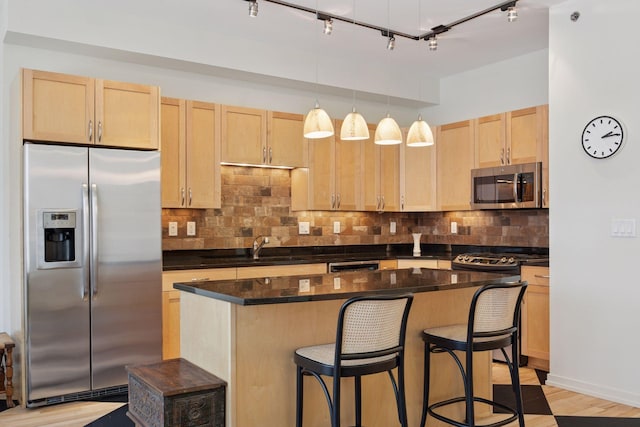 215 10th Ave S Unit 633, Minneapolis, MN 55415 - kitchen with stainless steel appliances, light brown cabinets, a sink, and dark countertops