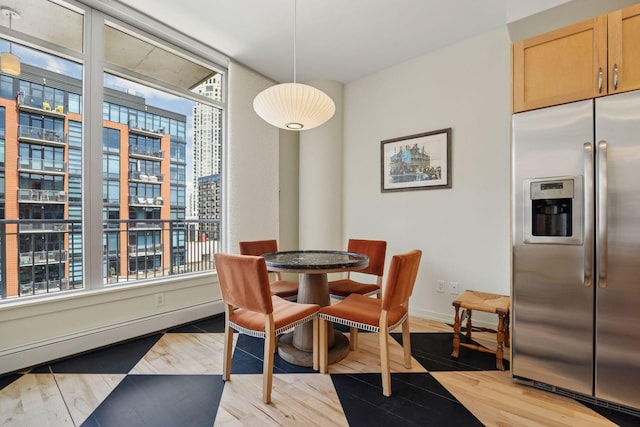 215 10th Ave S Unit 633, Minneapolis, MN 55415 - dining space featuring healthy amount of natural light, light wood finished floors, and baseboards