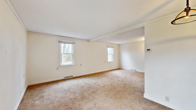 empty room with visible vents, baseboards, and carpet floors