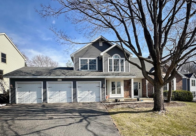 12776 Durham Way, Apple Valley, MN 55124 - traditional-style house featuring driveway, a garage, a shingled roof, brick siding, and a front lawn