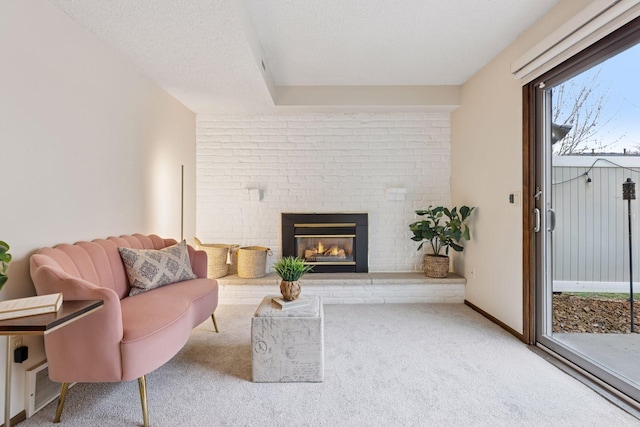 carpeted living room with a brick fireplace