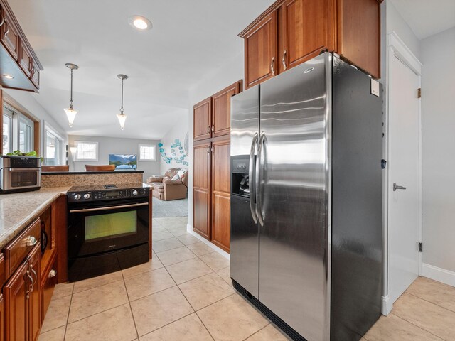 kitchen featuring stainless steel fridge with ice dispenser, black / electric stove, light tile patterned floors, decorative light fixtures, and brown cabinetry