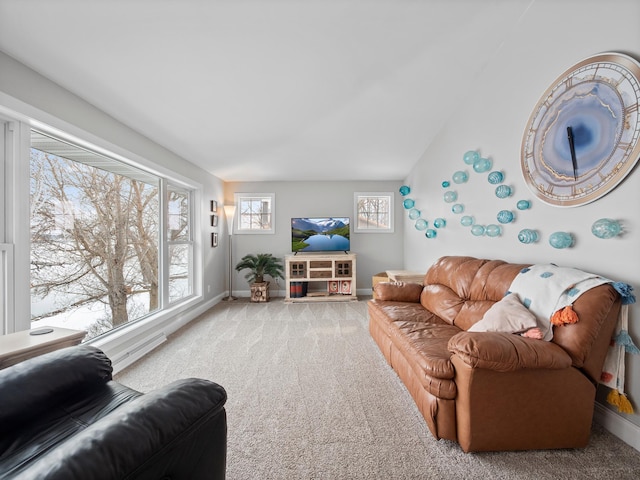 living area featuring carpet flooring and baseboards