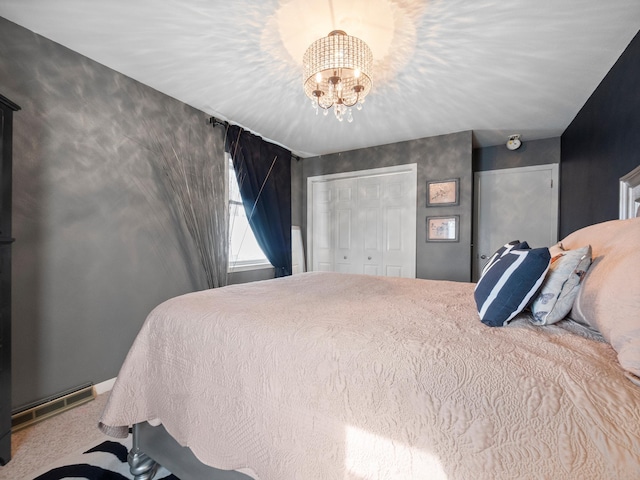 bedroom with a notable chandelier, a closet, visible vents, and carpet floors
