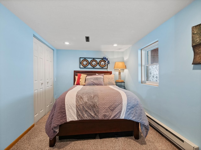 bedroom featuring visible vents, baseboards, a closet, carpet, and baseboard heating