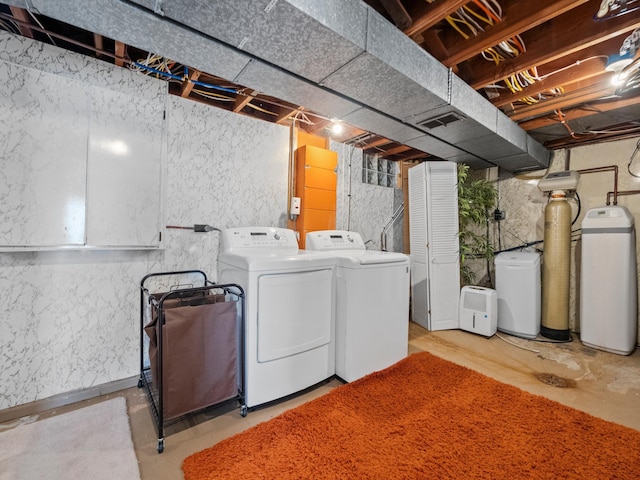 clothes washing area featuring washing machine and clothes dryer and laundry area