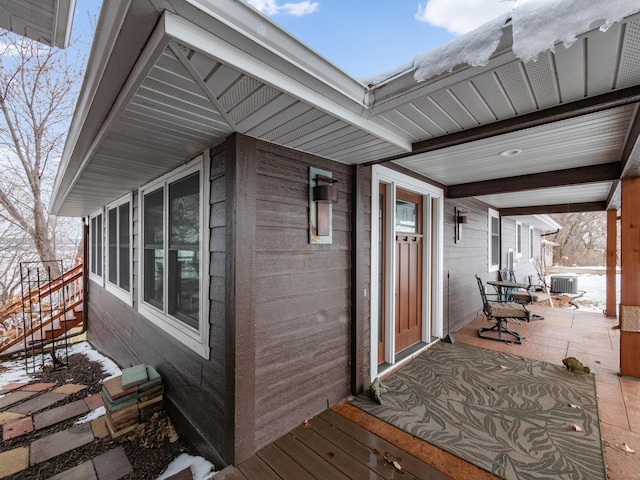 property entrance featuring central air condition unit and covered porch