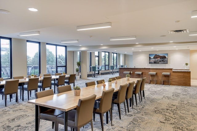 dining space featuring visible vents and floor to ceiling windows
