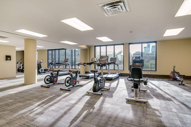 gym with carpet floors, baseboards, and visible vents