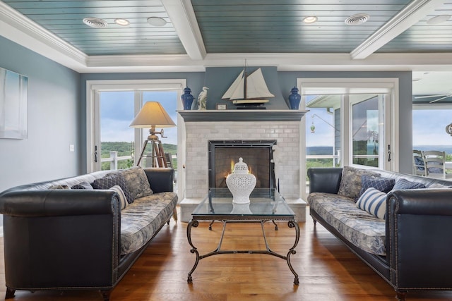 living room featuring a healthy amount of sunlight, wooden ceiling, a fireplace, and wood finished floors
