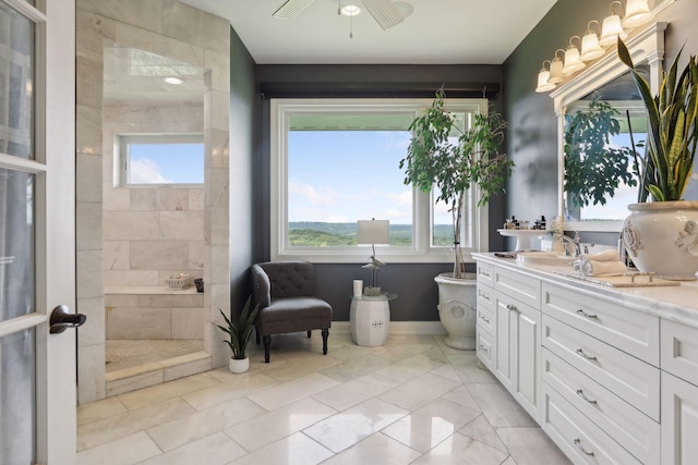 full bathroom with a freestanding bath, vanity, a ceiling fan, and a tile shower