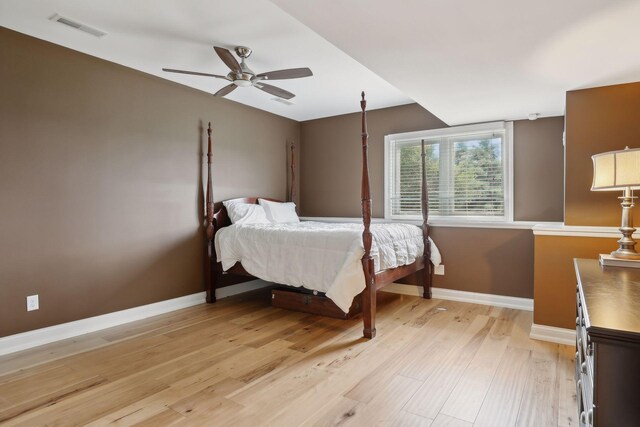 bedroom with visible vents, baseboards, ceiling fan, and light wood-style floors