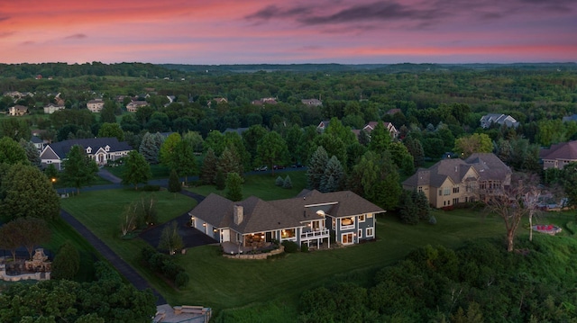 aerial view at dusk with a wooded view