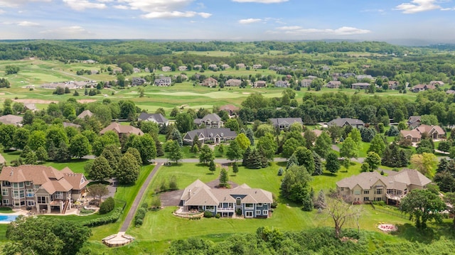 drone / aerial view featuring view of golf course and a residential view