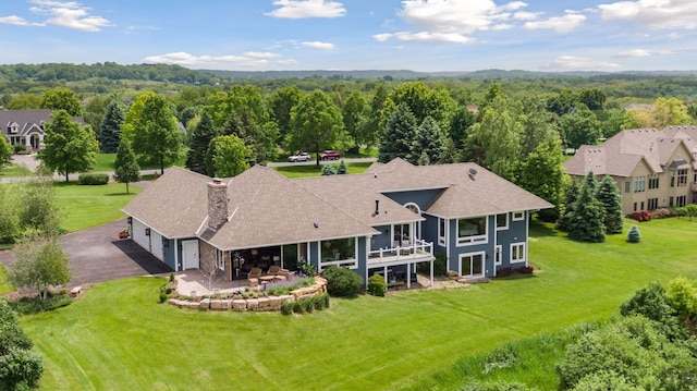 drone / aerial view featuring a view of trees