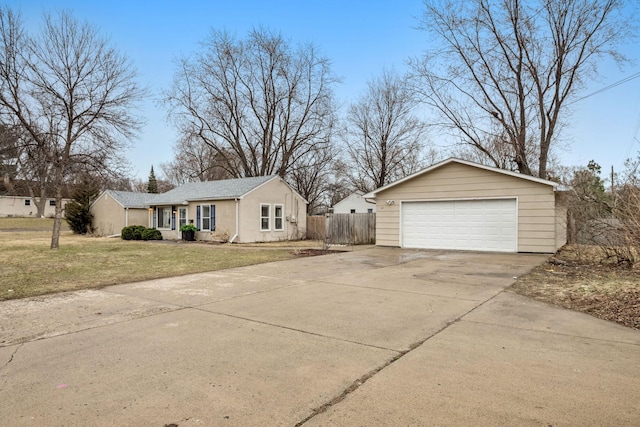 view of front of home featuring a garage, fence, and a front yard
