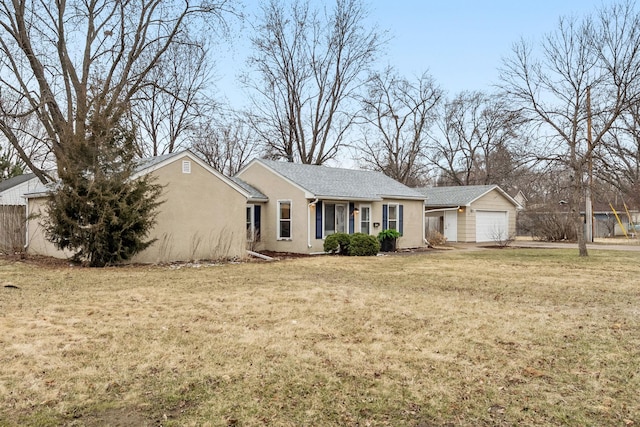 ranch-style home featuring a front yard, stucco siding, and a garage