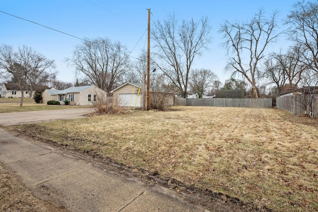 view of yard featuring a detached garage and fence
