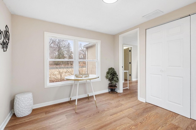interior space featuring a closet, baseboards, light wood-style floors, and visible vents